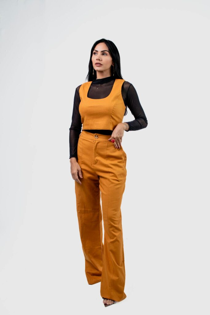 Elegant young woman in trendy fashion on white background.